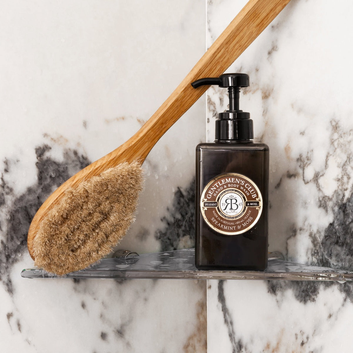 Gentlemen's Club' Spearmint & Moss Luxury Hand And Body Wash - Brown liquid Soap Dispenser Bottle with Brown & Dark Brown Gift Box - Lifestyle image showing Shower Brush next to the Hand & Body Wash in the shower.