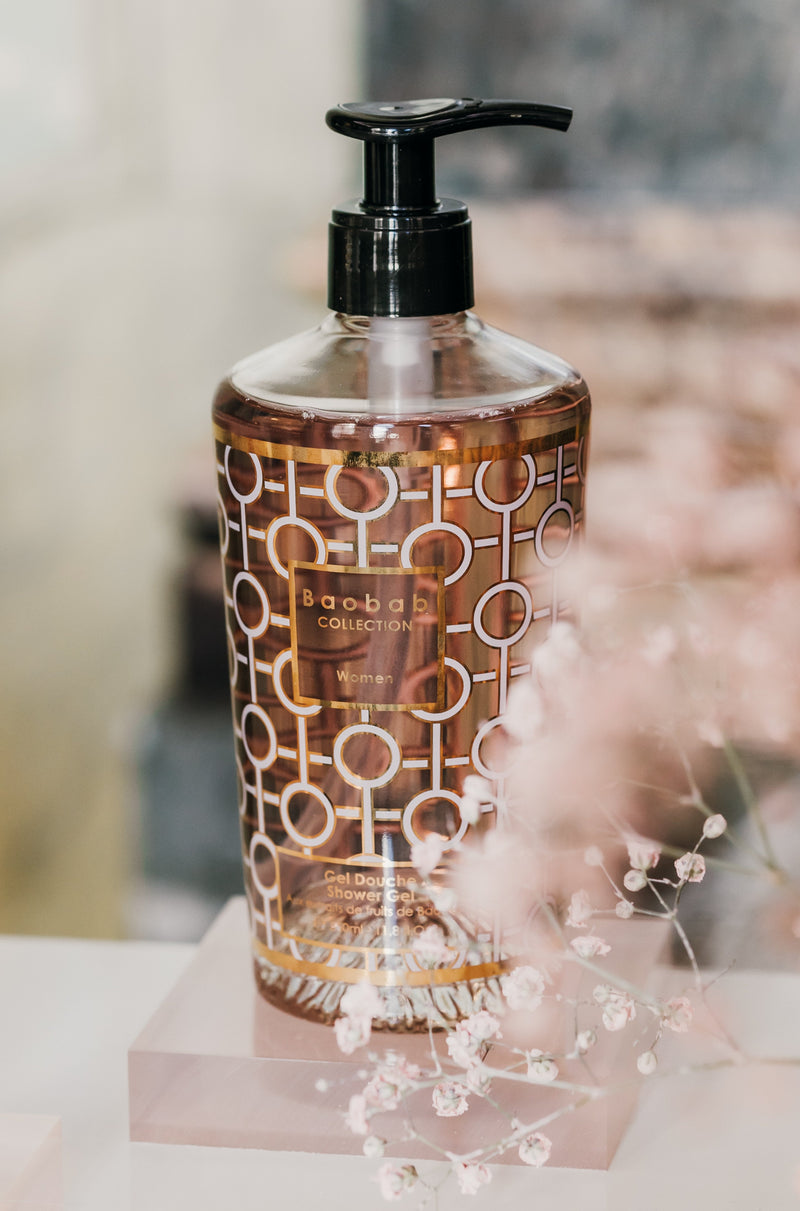 Baobab Shower Gel in Luxury Bottle. White circular pattern and pink gel is visible through the bottle