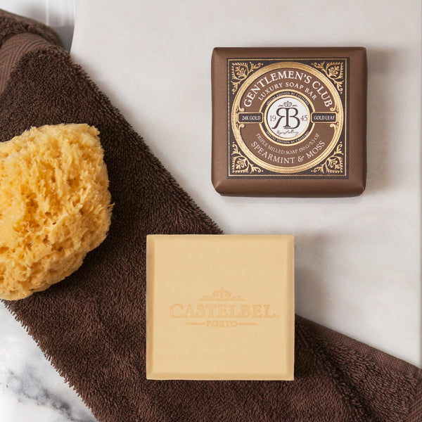 Gentlemen's Club Spearmint & Moss Soap 150g - Small cream coloured square soap in decorative brown & Gold packaging. - Lifestyle image.